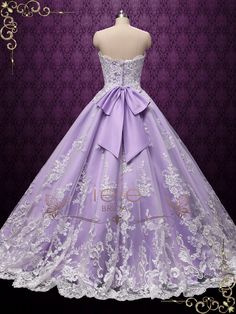 a purple dress with white lace on the bottom and a large bow at the waist