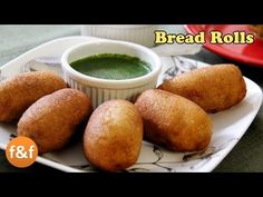 bread rolls on a plate with dipping sauce