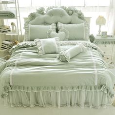 a bed with ruffled bedspread and pillows