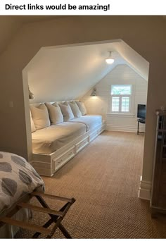 an attic bedroom with white bedding and beige carpeted flooring, built - in storage space