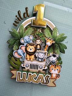 the number one sign for lucas's first birthday is decorated with animals and palm trees