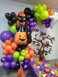 an assortment of halloween themed balloons and decorations