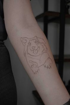 a person with a tattoo on their arm that has a bear drawn on the side