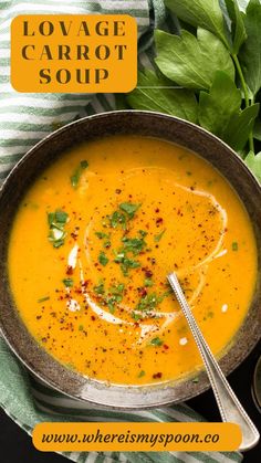 a bowl filled with carrot soup on top of a table