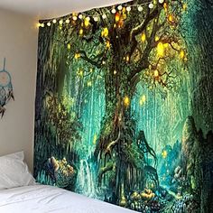 a bedroom with a large wall mural on the wall and lights hanging from the tree