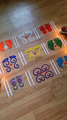 a wooden floor covered in lots of different types of crafts and lights next to candles