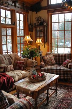 a living room with couches, tables and lamps on the windows sill in front of them