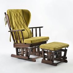 an old rocking chair and footstool with a yellow cushion on the seat, against a white background