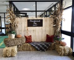 hay bales are stacked on top of each other in front of a sign that reads congratulations day