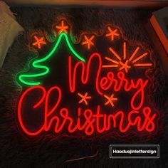 a neon sign that says merry christmas on it