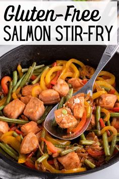 a skillet filled with chicken, green beans and red bell peppers that have been stir fried