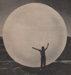 a man standing in front of a giant white ball