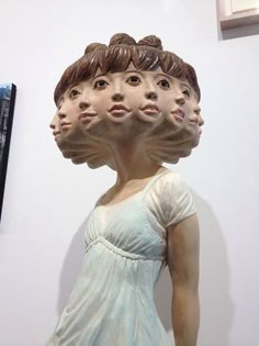 a group of people's heads in the shape of faces on display at a museum