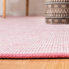 a close up of a pink rug on the floor