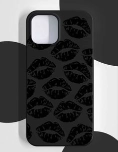 an iphone case with black lips on it, against a white and black wallpaper