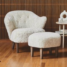 a white chair and ottoman in a room