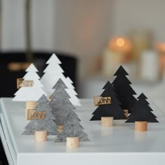 three small wooden trees sitting on top of a table