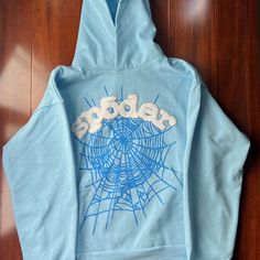 Brand New Xl Baby Blue Sp5der Hoodie Never Been Worn I Ordered The Wrong Size Message Me For Offers Blue Hooded Top For Streetwear, Trendy Blue Winter Sweatshirt, Trendy Blue Winter Hoodie, Blue Drawstring Hood Top For Streetwear, Trendy Blue Top With Drawstring Hood, Trendy Blue Tops With Drawstring Hood, Blue Cotton Outerwear With Letter Print, Light Blue Letter Print Sweatshirt For Fall, Light Blue Sweatshirt For Spring Streetwear