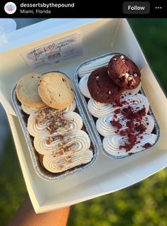 an open box filled with assorted cookies and desserts