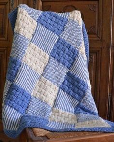 a blue and white blanket sitting on top of a wooden chair