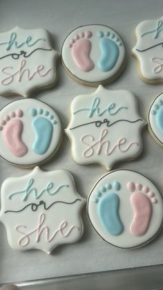 decorated cookies in the shape of footprints with words on them that say she she she