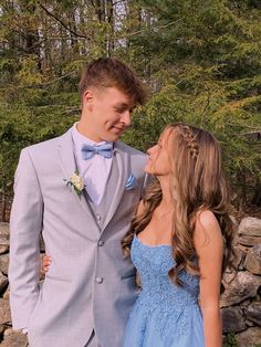 a man and woman in formal wear standing next to each other