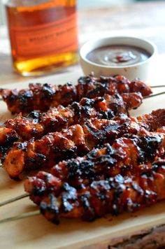 bbq chicken skewers with barbecue sauce on the side