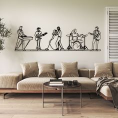 a living room with a couch, table and wall art on the wall above it