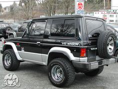 a black and silver jeep parked in a parking lot