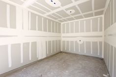 an empty room with white paint on the walls