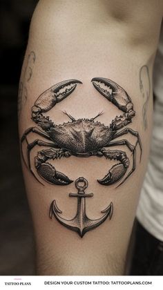 a crab and anchor tattoo on the thigh