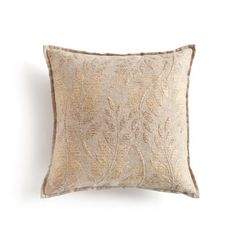 an embroidered pillow with gold leaves on the front and back, against a white background