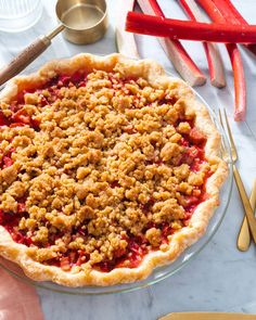 a pie sitting on top of a table next to utensils