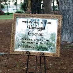 a welcome sign in front of a tree