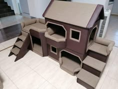 a house made out of cardboard sitting on the floor