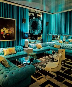 a living room filled with lots of blue couches