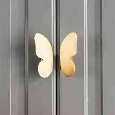 a close up of a door handle on a glass door with a butterfly shaped design