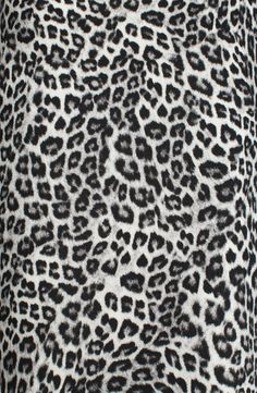 an animal print fabric with black and white spots on the top, as well as dark grey