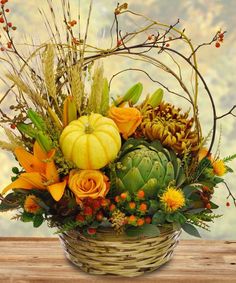 a basket filled with lots of different types of flowers and plants on top of each other