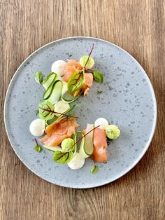 a blue plate topped with food on top of a wooden table