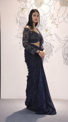 Navy Blue Lycra Net drape saree with a beautiful Net blouse with Cutdana Sequin details.The saree is the perfect choice for a party or an event where one can be chic yet graceful.-Slight variation in color is possible due to digital photography. Style: Drape Saree Fabric: Net with Laycra Work: Sequin, Cut dana Colour: Navy Blue Chest: 36 Note:- Originally Stitched in 36 but can alter for size 34 without any extra cost. Festive Blue Pre-draped Saree For Evening, Glamorous Pre-draped Saree With Resham Embroidery For Reception, Festive Pre-draped Saree With Zari Work For Party, Glamorous Pre-draped Saree For Reception And Navratri, Festive Pre-draped Saree For Party Season, Bollywood Georgette Pre-draped Saree For Party, Floor-length Cutdana Choli For Evening, Party Wear Pre-draped Saree With Zari Work For Diwali, Glamorous Pre-draped Saree With Cutdana For Party