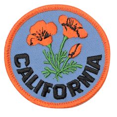 an embroidered patch with the words california and three orange flowers in black lettering on it