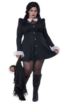 a woman in a black dress and white collared shirt is holding a teddy bear