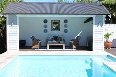 a pool with chairs and a table next to it