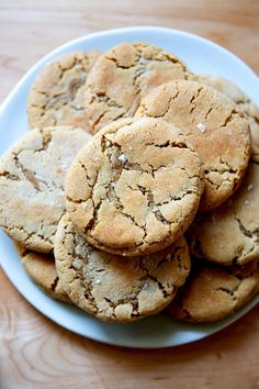 a white plate topped with cookies on top of a wooden table