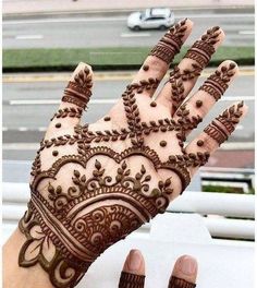 the hand is decorated with henna designs on it's fingers and hands are shown