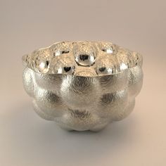 a silver bowl sitting on top of a table