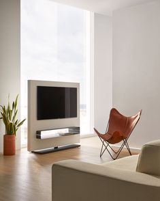 a living room with a large flat screen tv mounted to the side of a wall