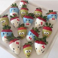 there are many strawberries decorated to look like characters on the same plate as each other