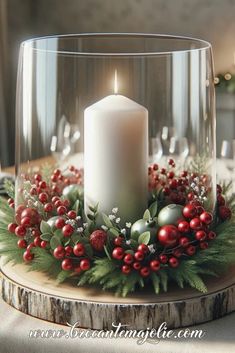 a candle is lit on top of a table with greenery and berries around it